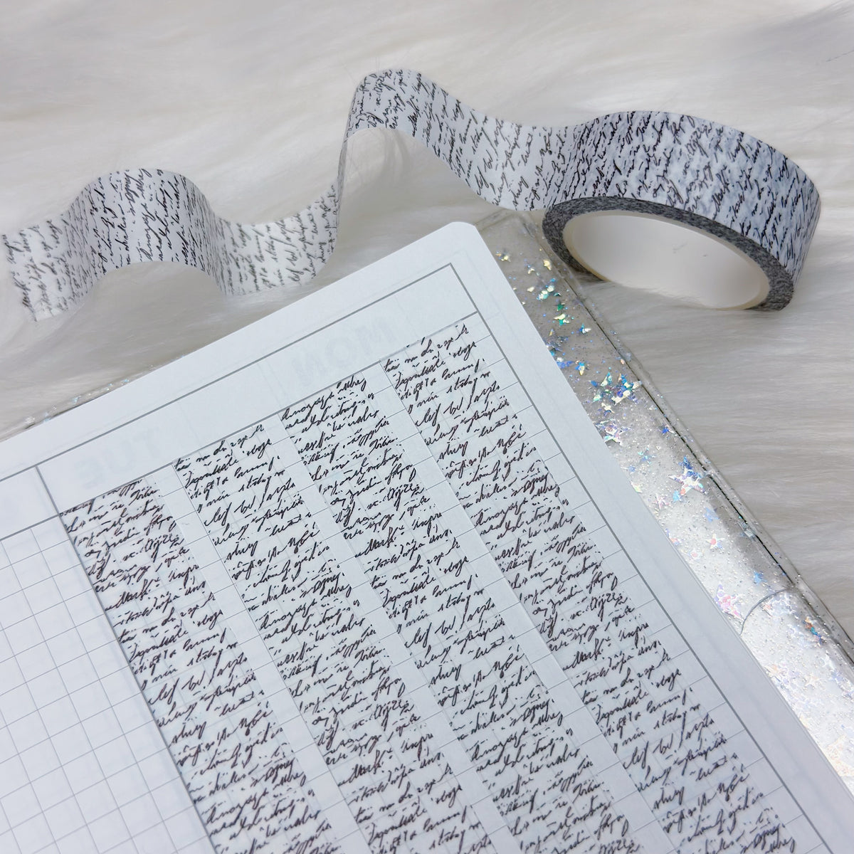 Roll of washi tape with black text on a white surface