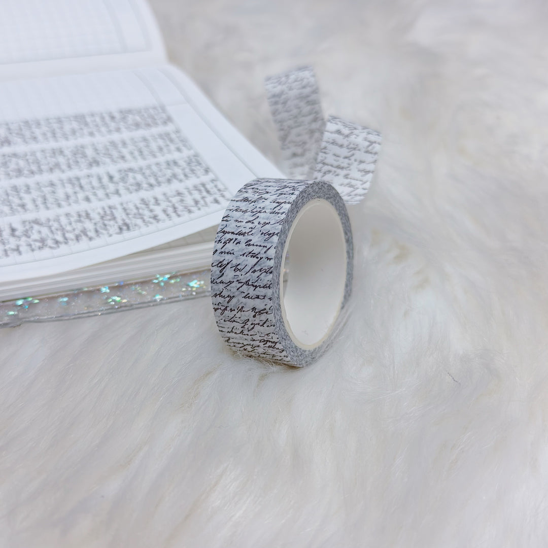 Roll of decorative tape with text on a white surface
