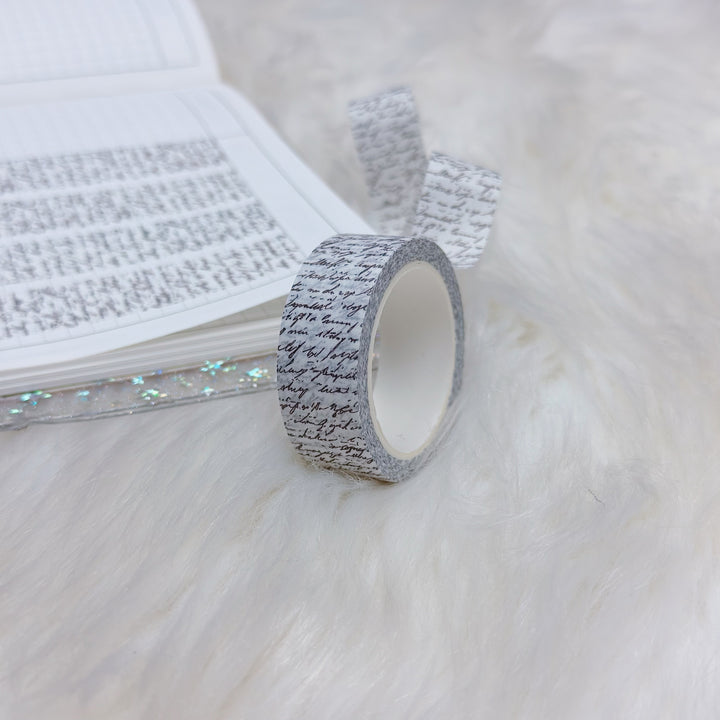 Roll of decorative tape with text on a white surface